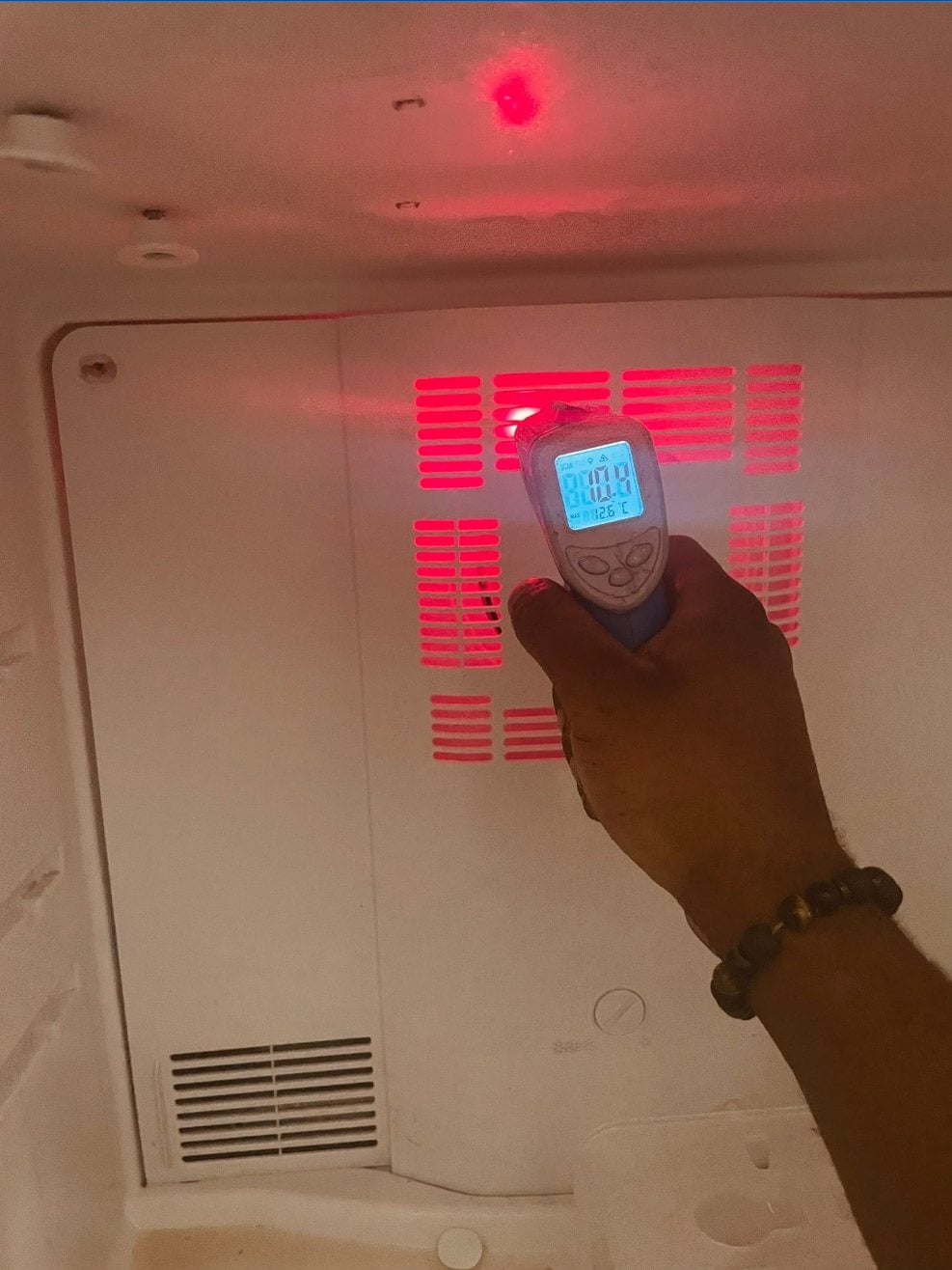 Taking a temperature reading inside a freezer compartment